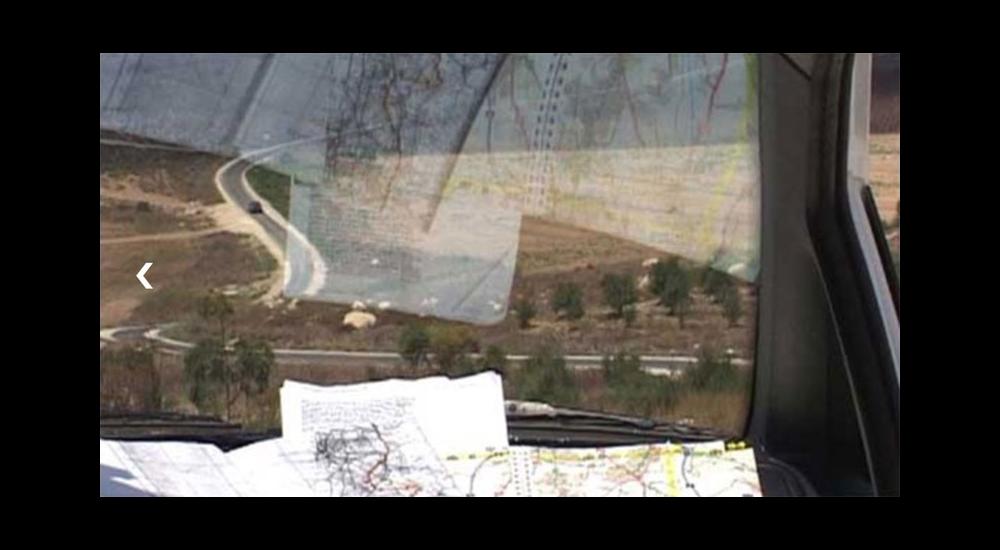 Still from the film of a landscape seen from a car