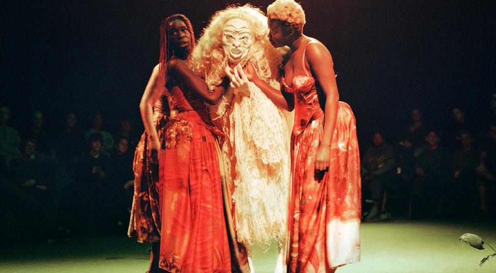 Three figures on stage