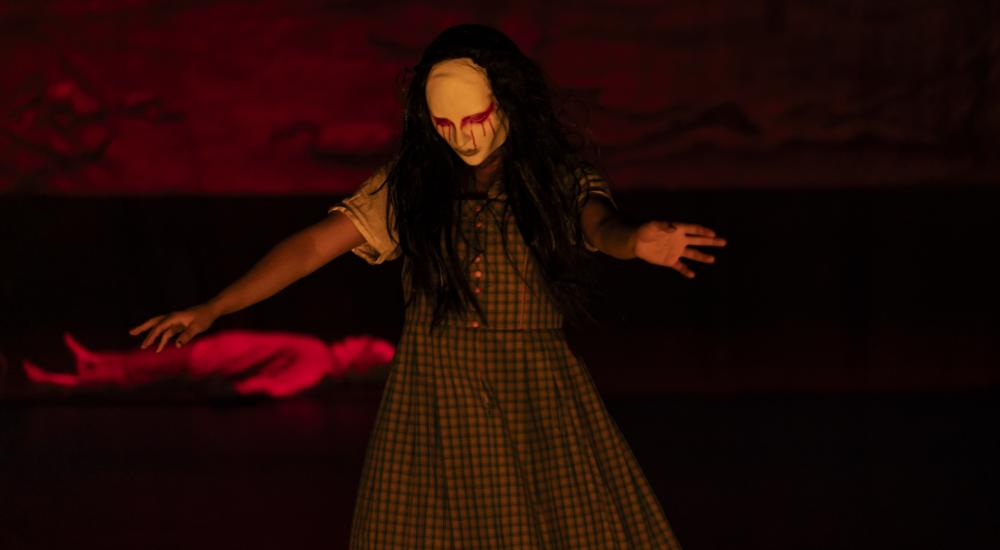 A dancer with white and red makeup on