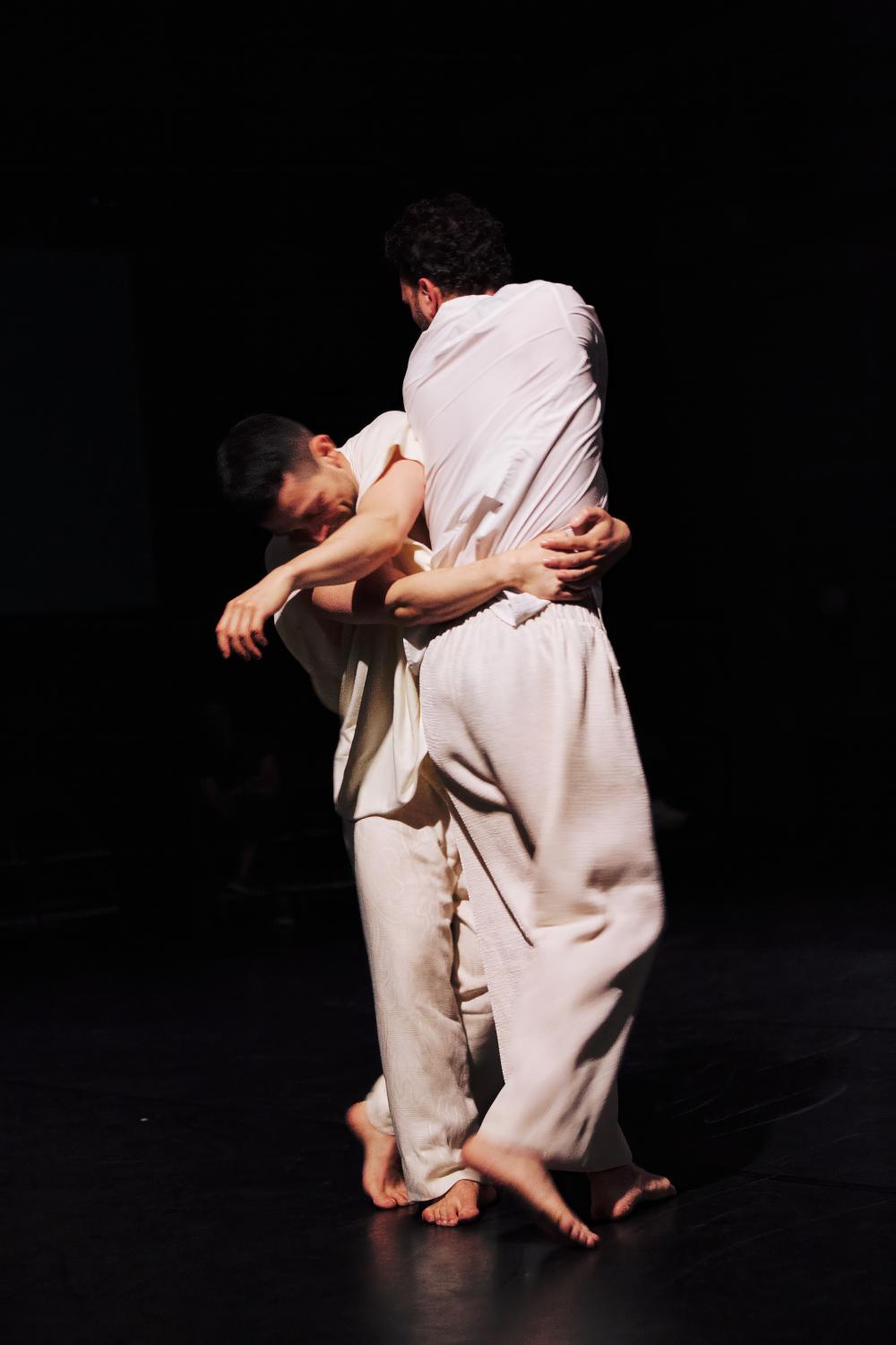 two dancers wrapped closely around each other