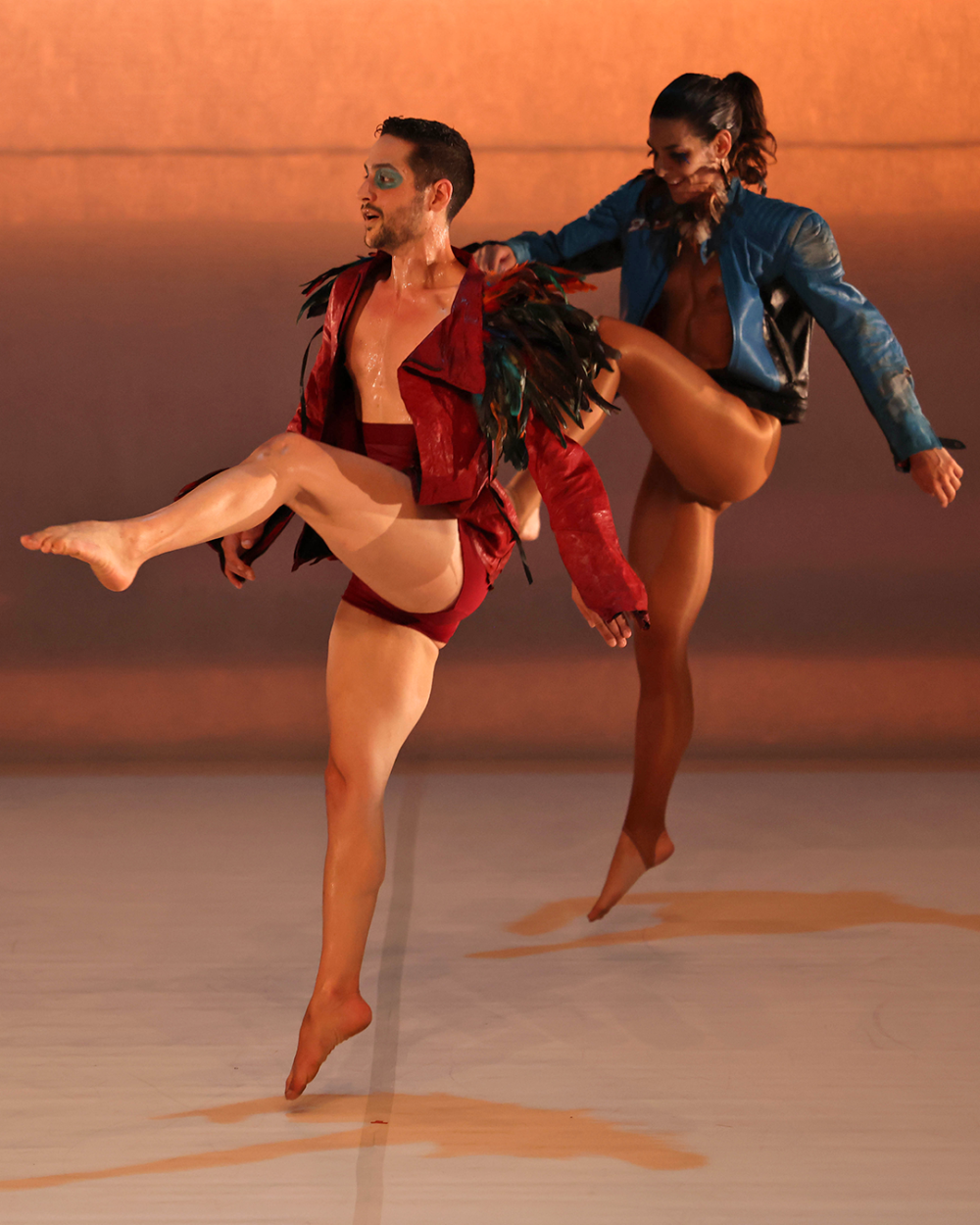 dancers jumping with one leg up