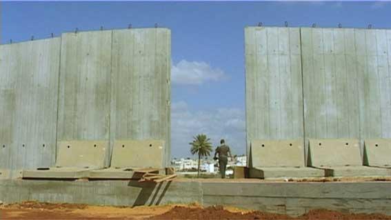 Still from the film of a border wall under construction