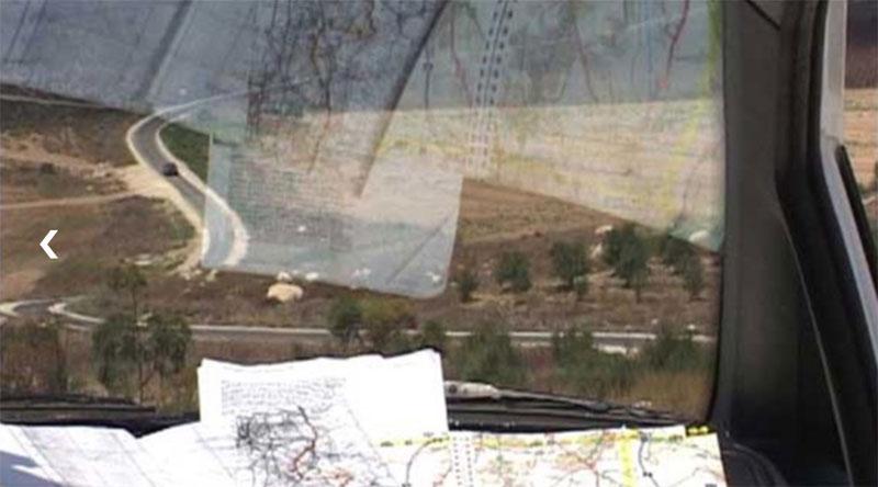 Still from the film of a landscape seen from a car