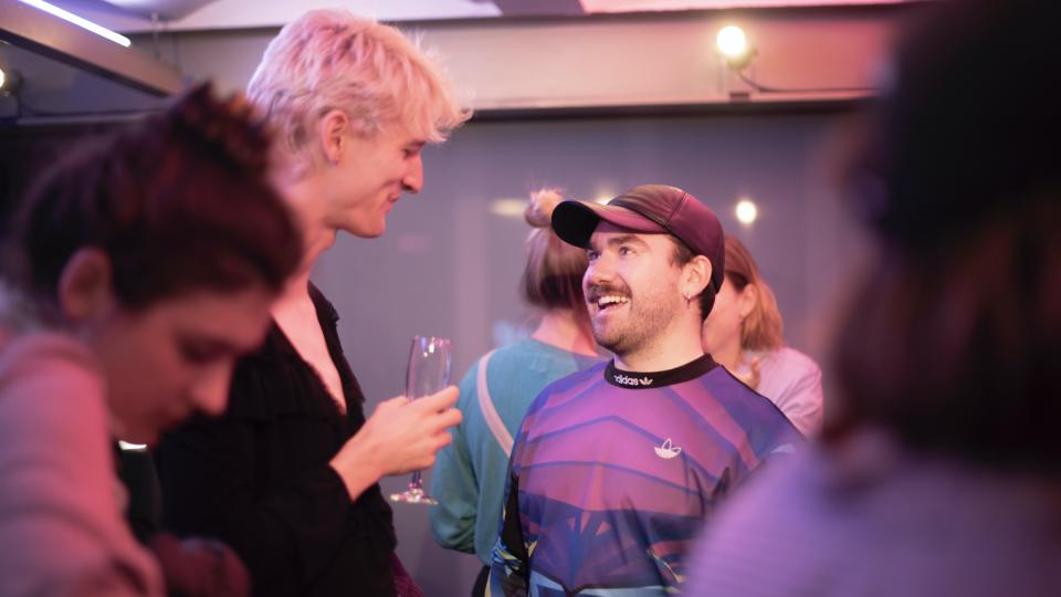 Two people talking at a party