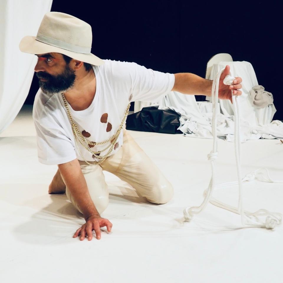 person with a white hat crawling on the floor