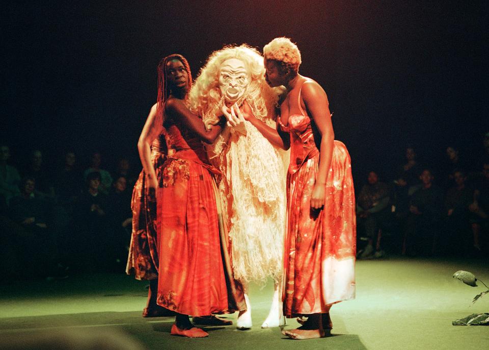 Three figures on stage