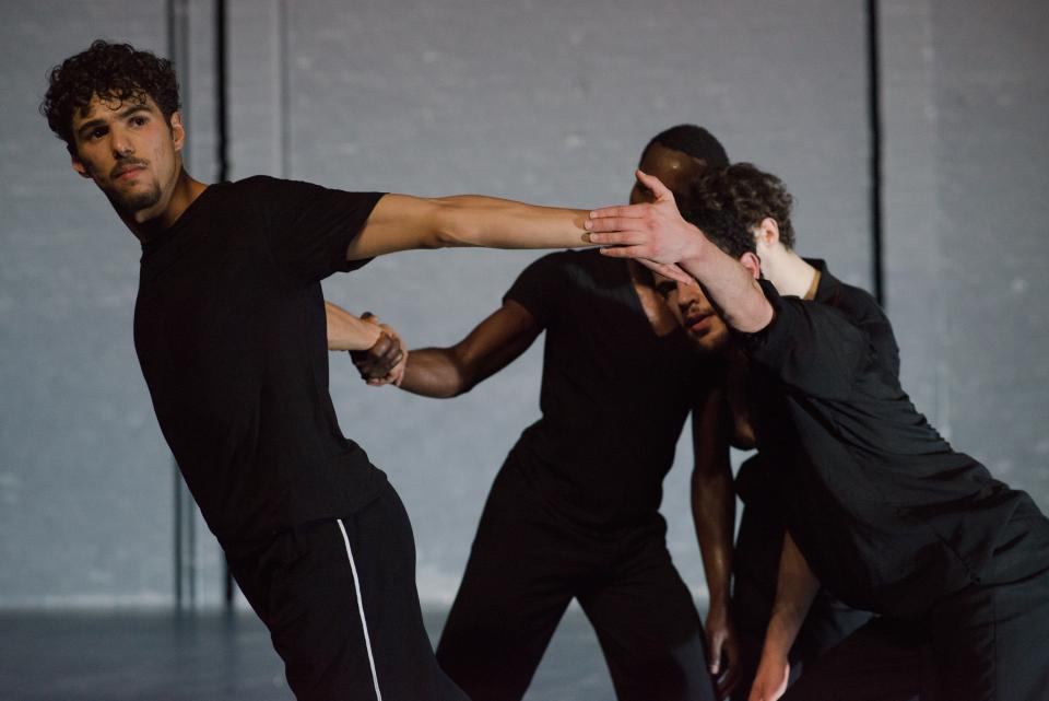 3 male dancers wearing black clothes