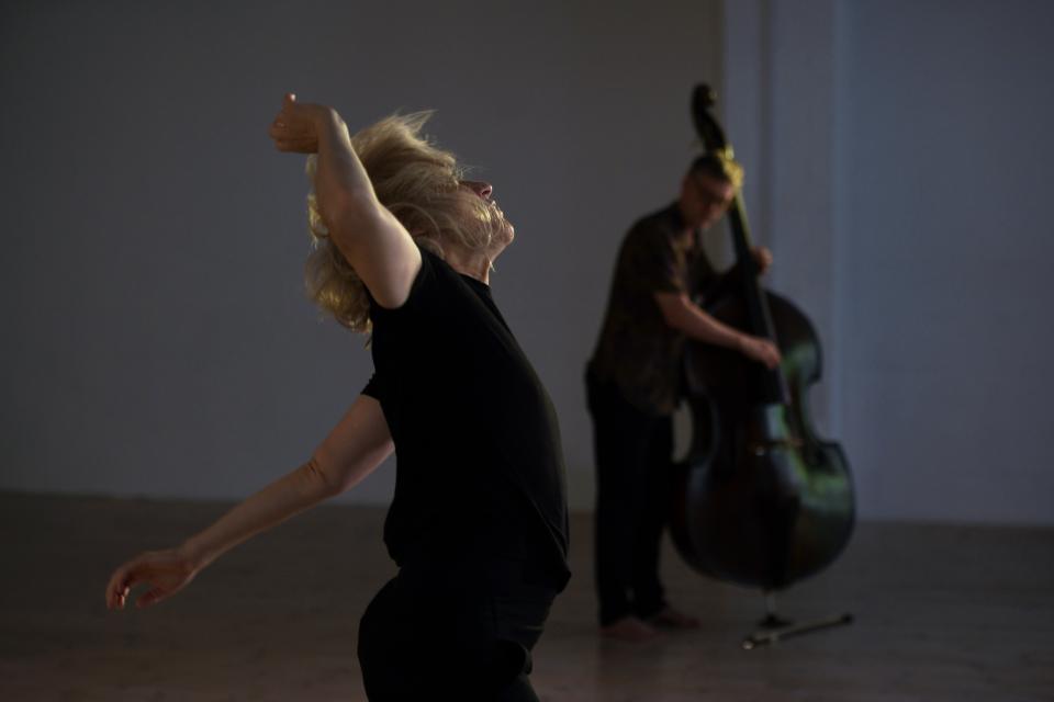 Dancing performer with double bass player