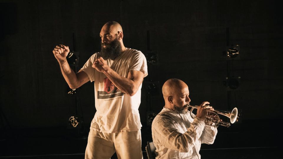boxing man next to a trumpet player