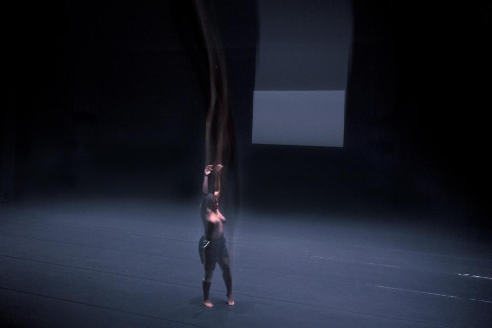 Black person in spotlight on stage 