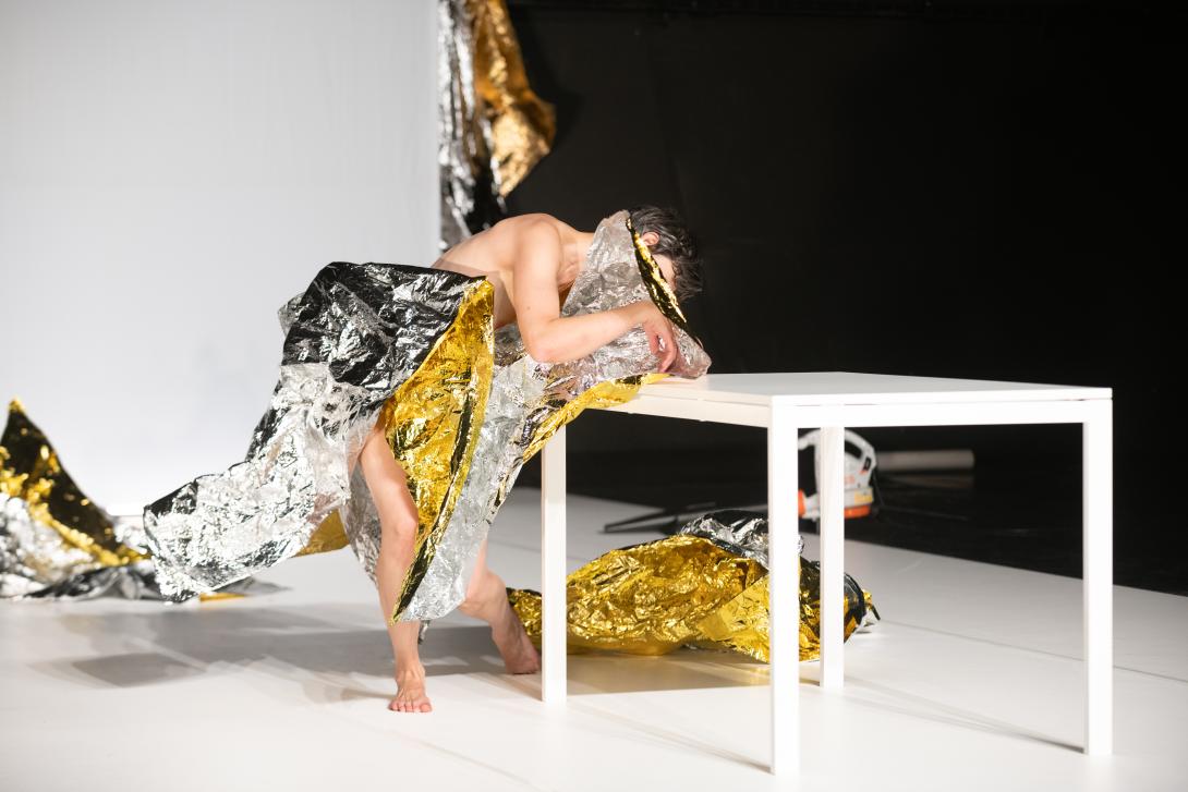 Manon Santkin wripped in tinfoil leaning on a table
